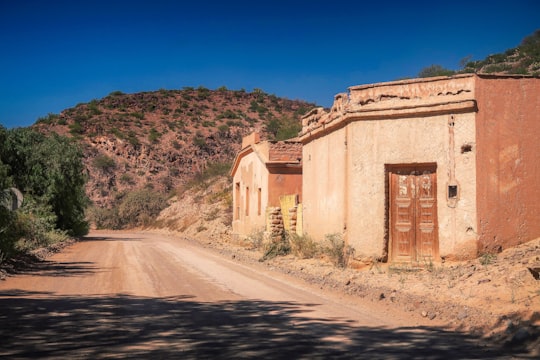 brown concrete building near green trees during daytime in Salta Argentina