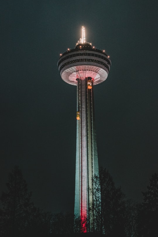 green and white tower during night time in Fallsview Tourist Area Canada