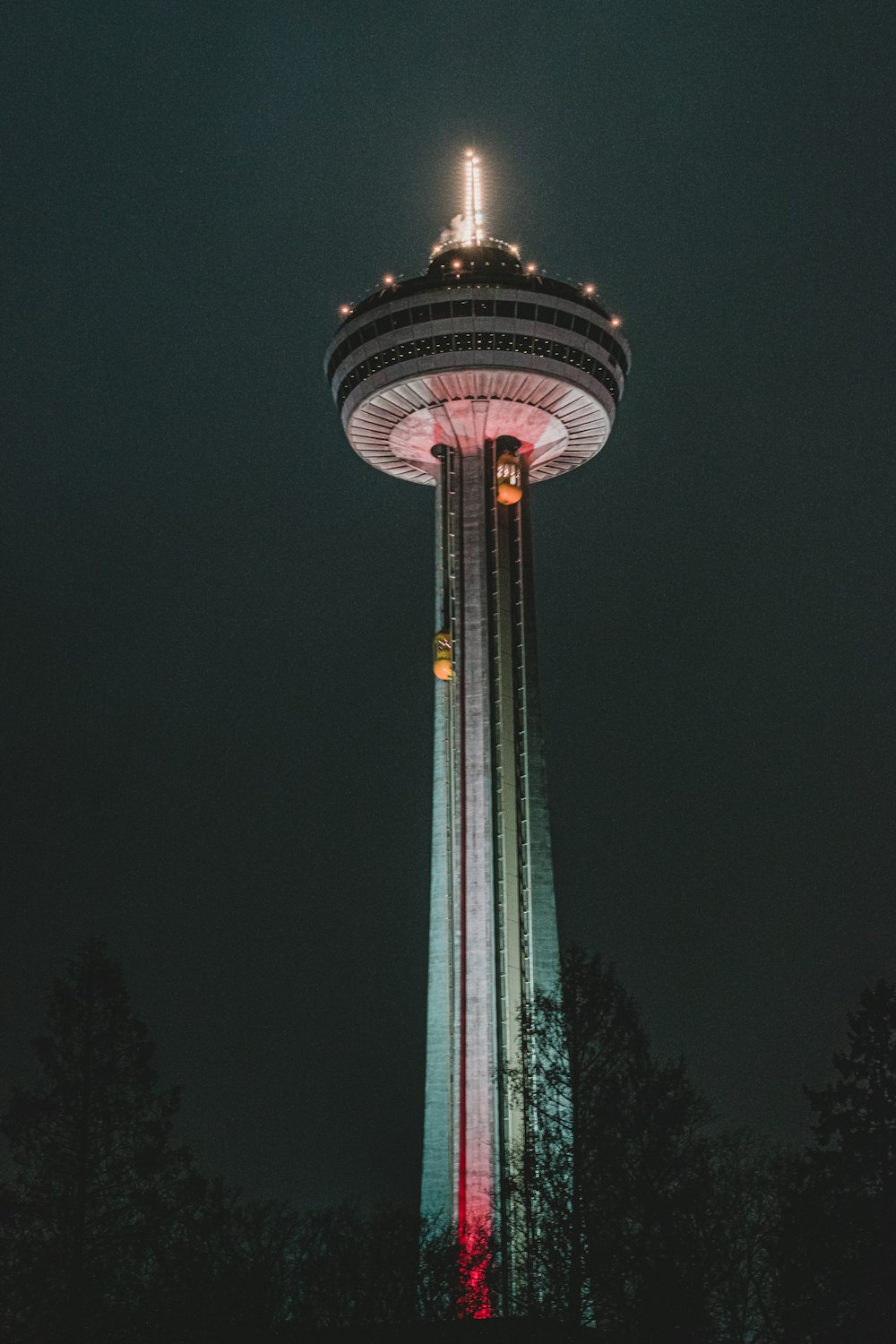 green and white tower during night time