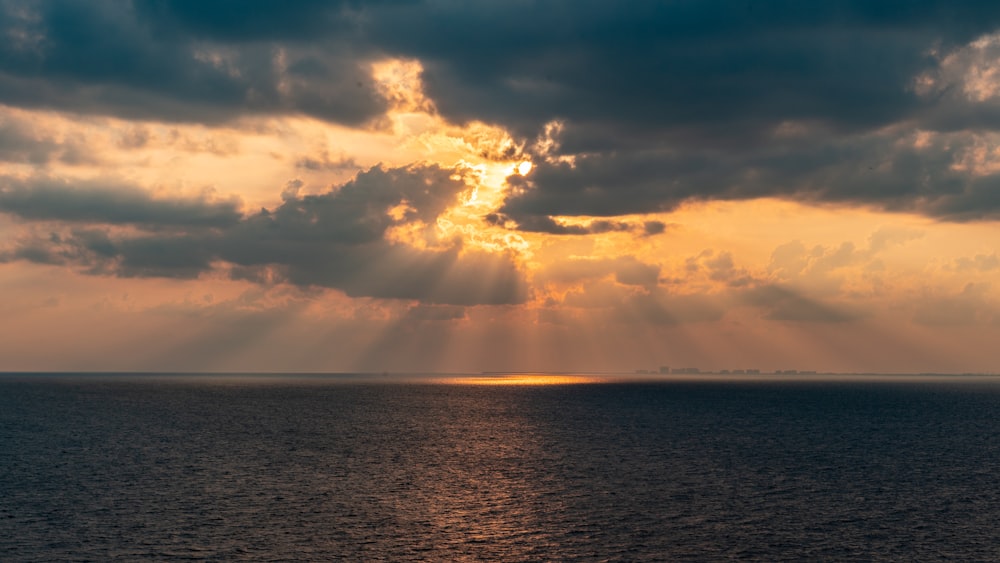 body of water under cloudy sky during daytime