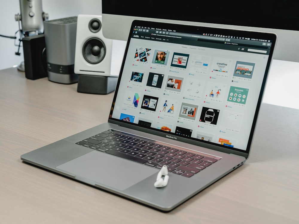 macbook pro on brown wooden table