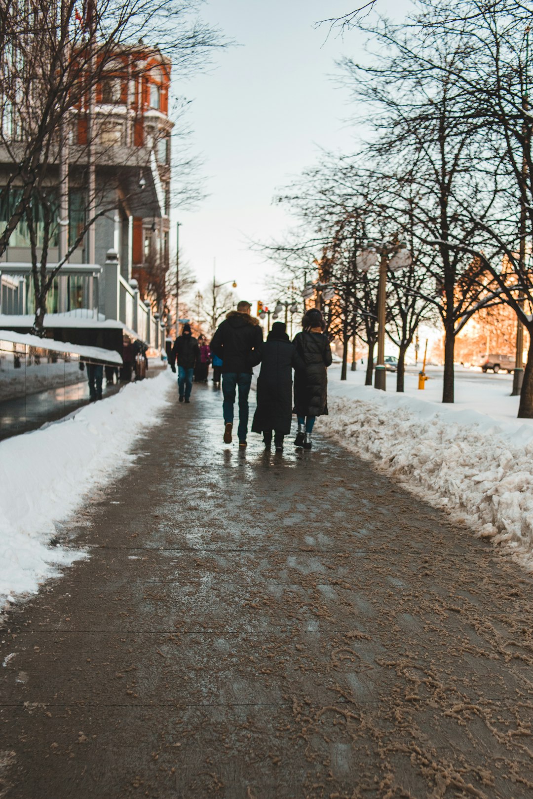 people walking on snow covered pathway during daytime