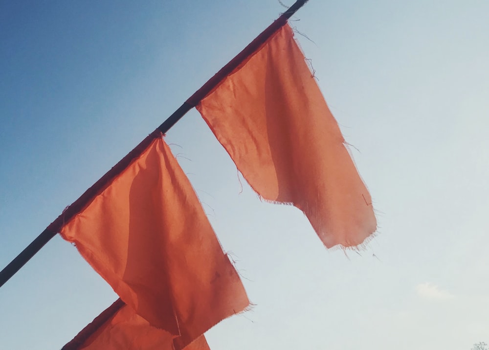 orange and white flag on black metal pole
