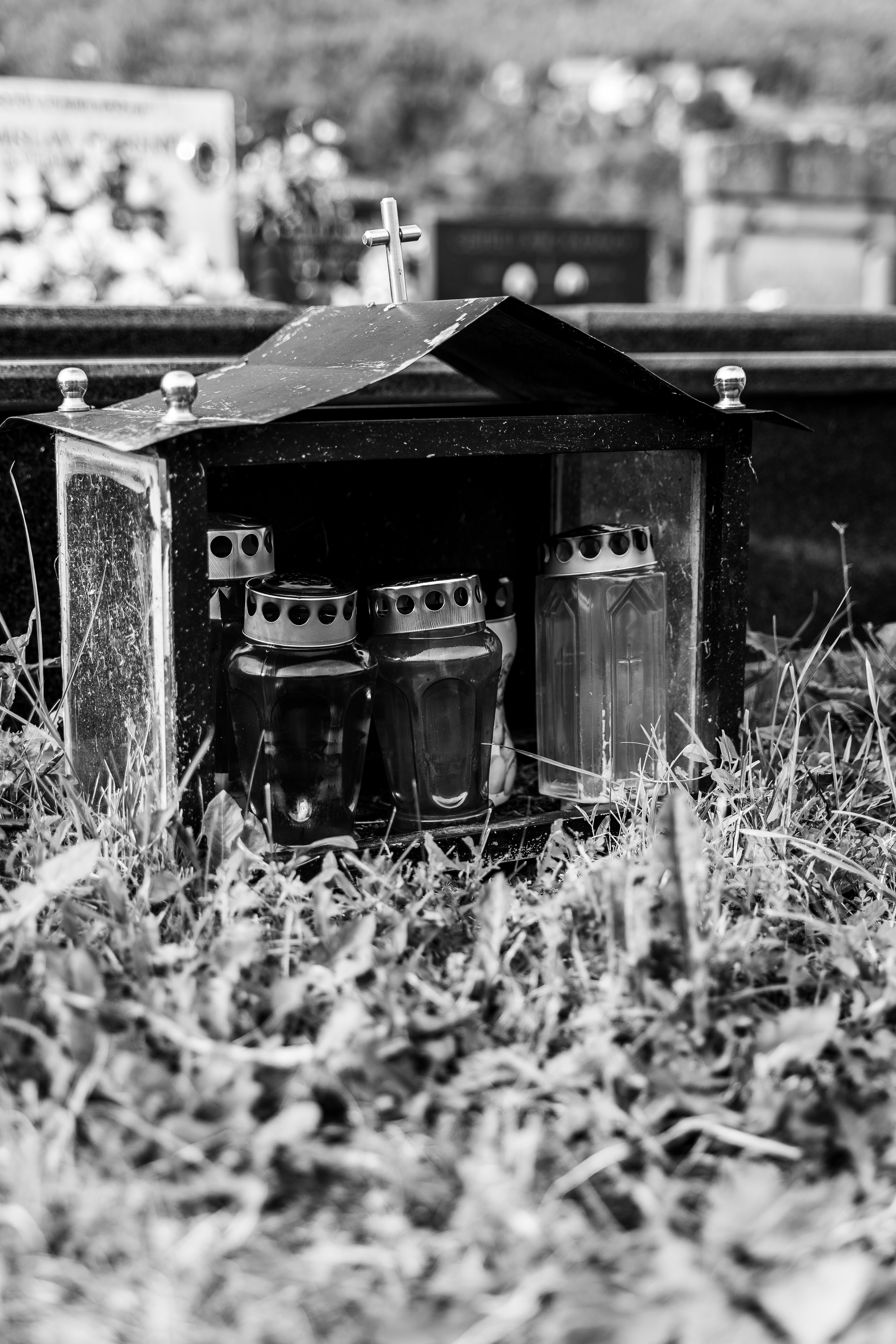 grayscale photo of 2 glass mugs on wooden box