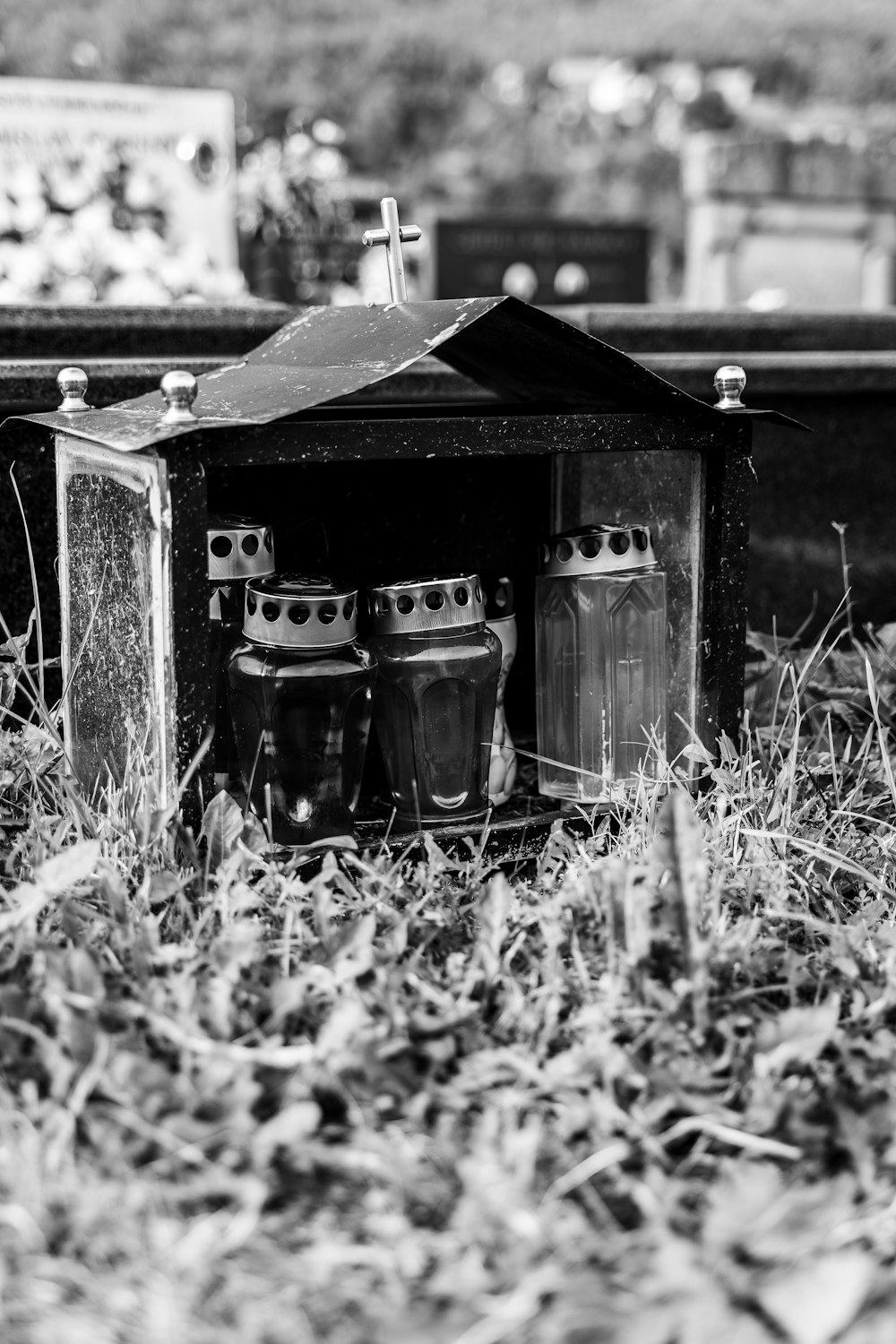 grayscale photo of 2 glass mugs on wooden box