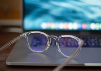 silver framed eyeglasses on white table