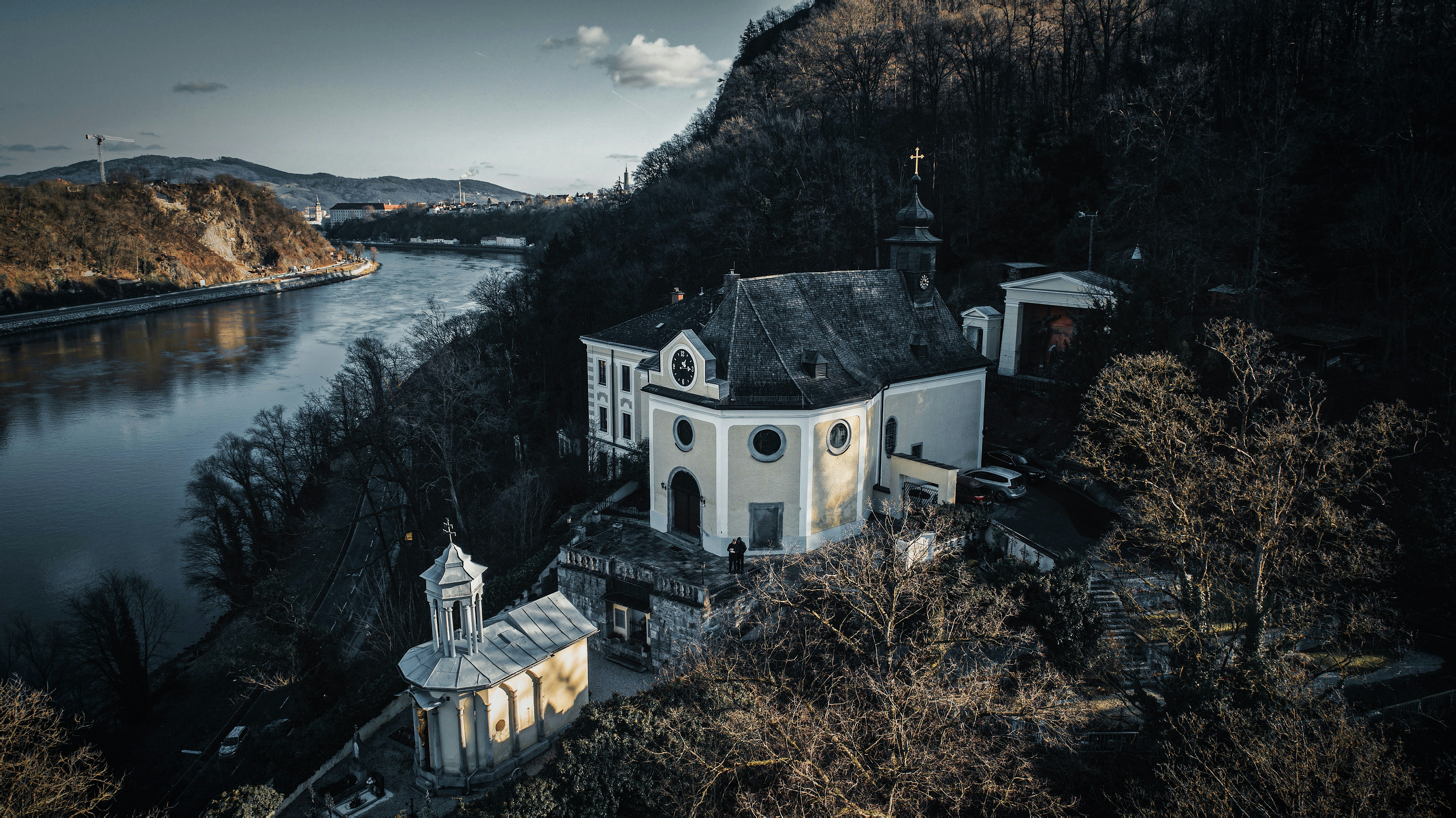 white and black concrete building near body of water during daytime