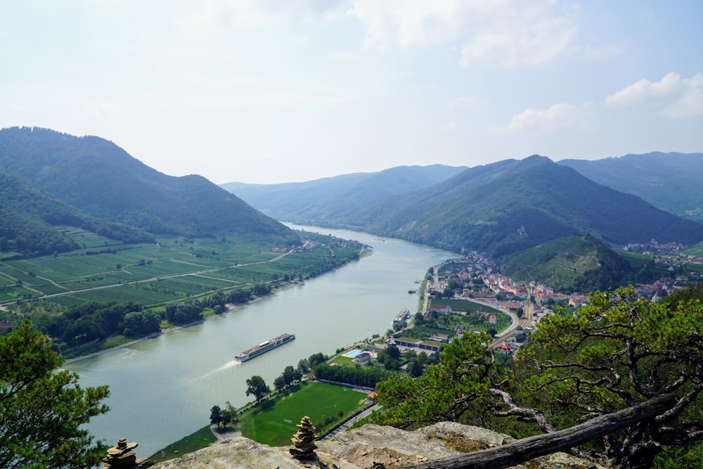 aerial view of green mountains and green trees near body of water during daytime