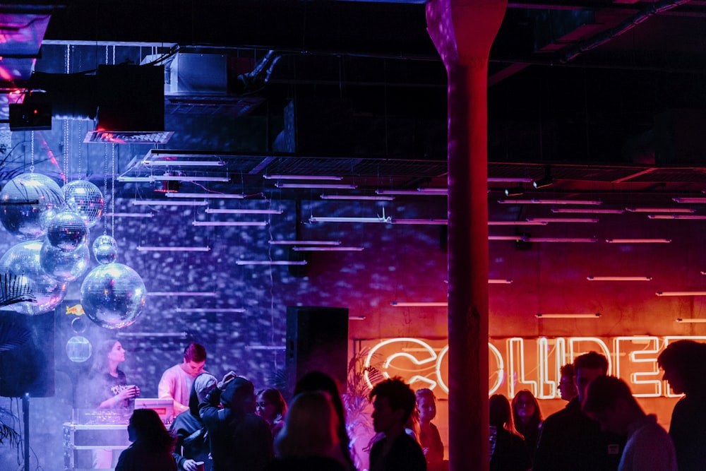 people standing on stage with red lights