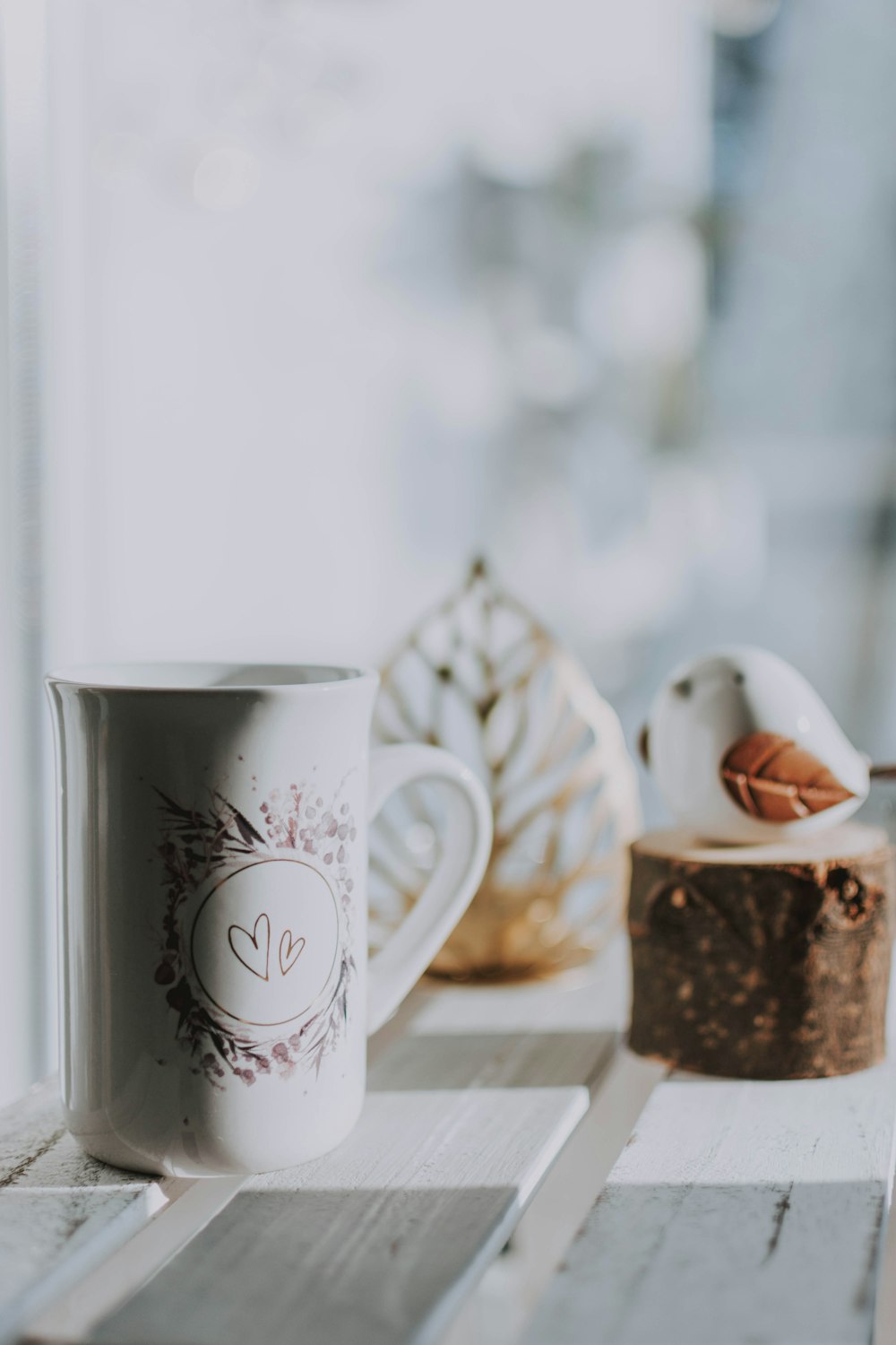 white ceramic mug beside white ceramic mug on brown wooden table