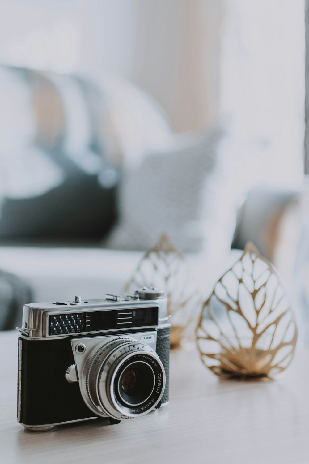 black and silver camera on white textile