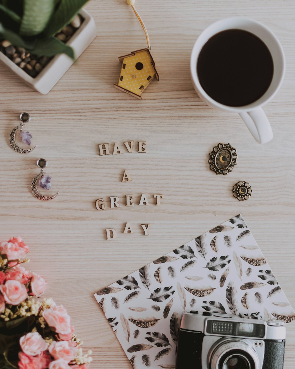 happy birthday greeting card beside white ceramic mug with coffee