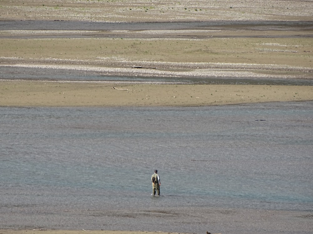 a man standing in a body of water