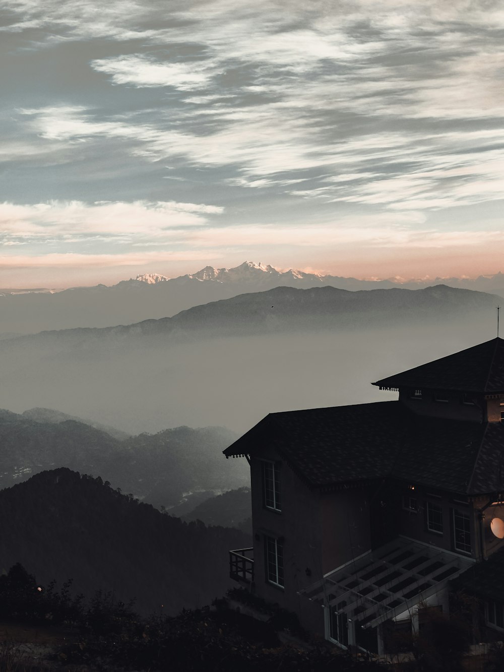 brown and white house on top of mountain