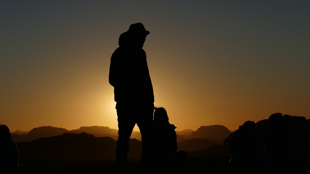 silhouette of man standing during sunset