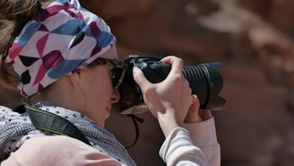 A candid shot of Sami Ur Rahman adjusting his camera during a vibrant outdoor photo session.
