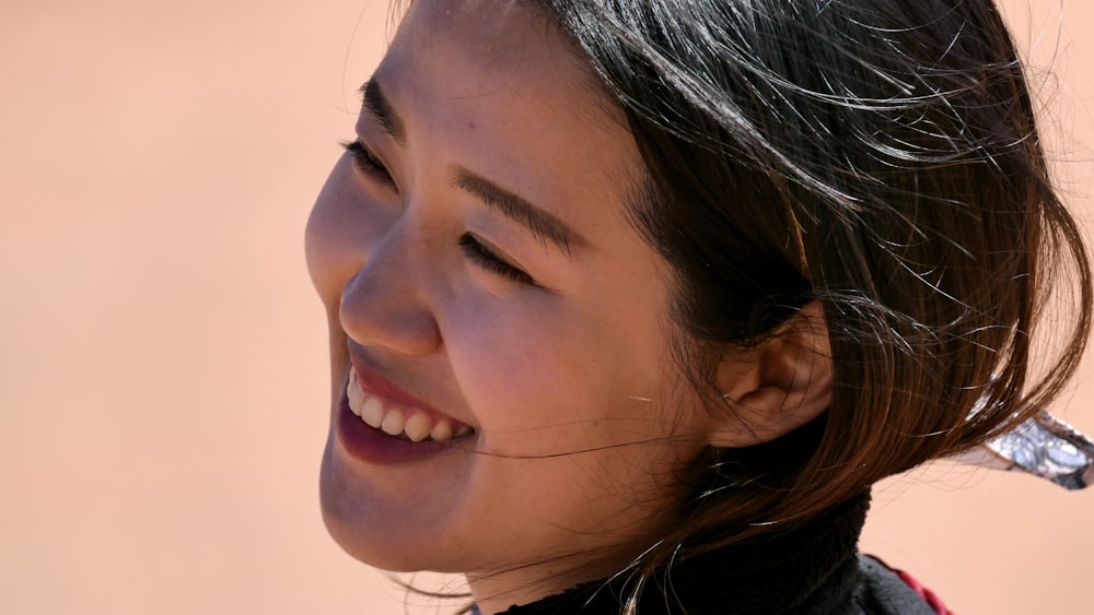 smiling woman in white shirt