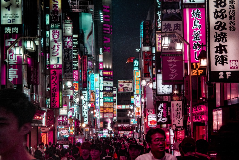 people walking on street during night time