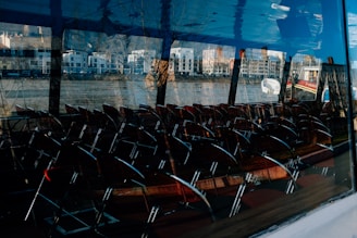 A frustrated person looking at a blank chair across from them, illustrating the problem of no-shows in meetings.