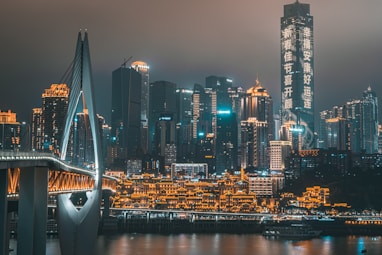 white boat on water near city buildings during night time