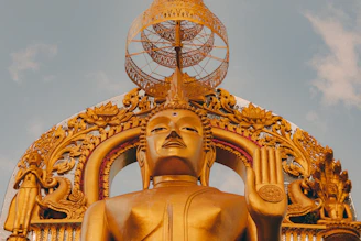 gold statue under blue sky during daytime