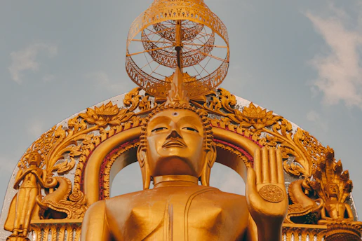gold statue under blue sky during daytime