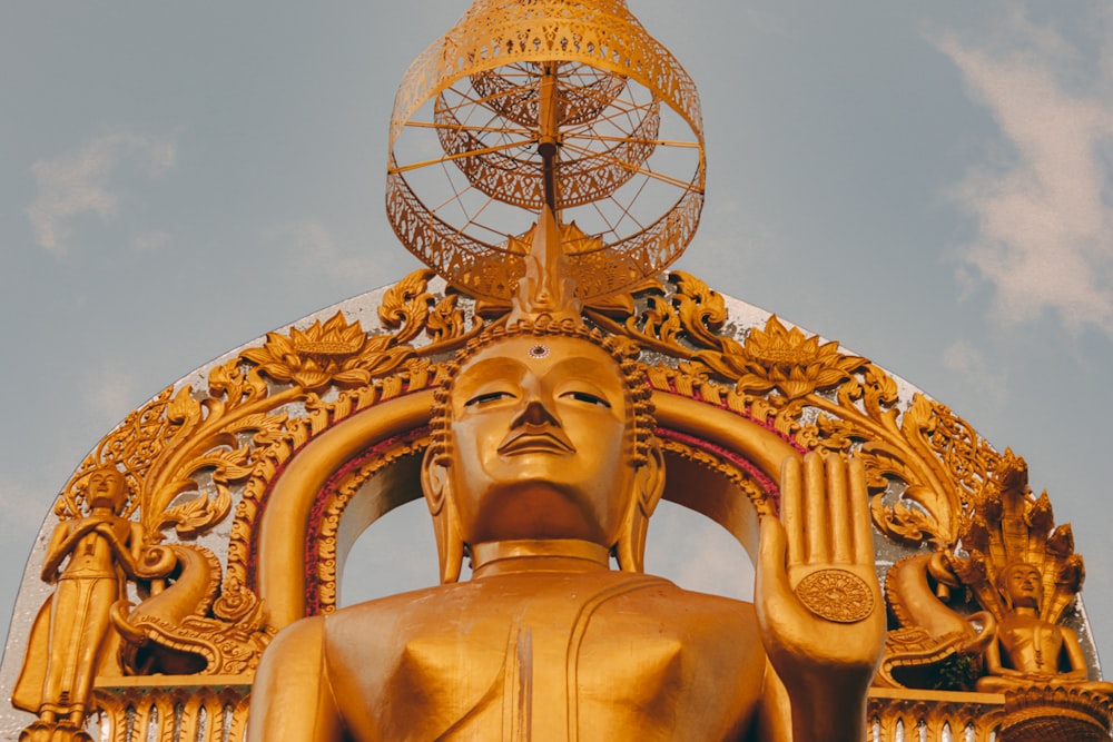 gold statue under blue sky during daytime