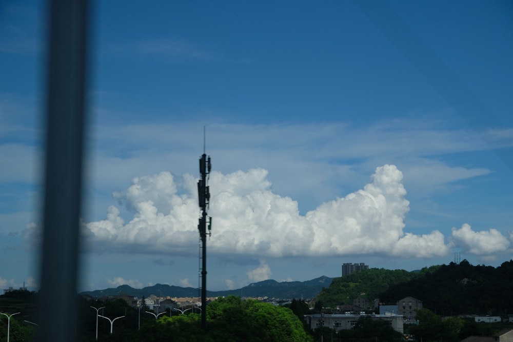 white clouds over green trees and buildings