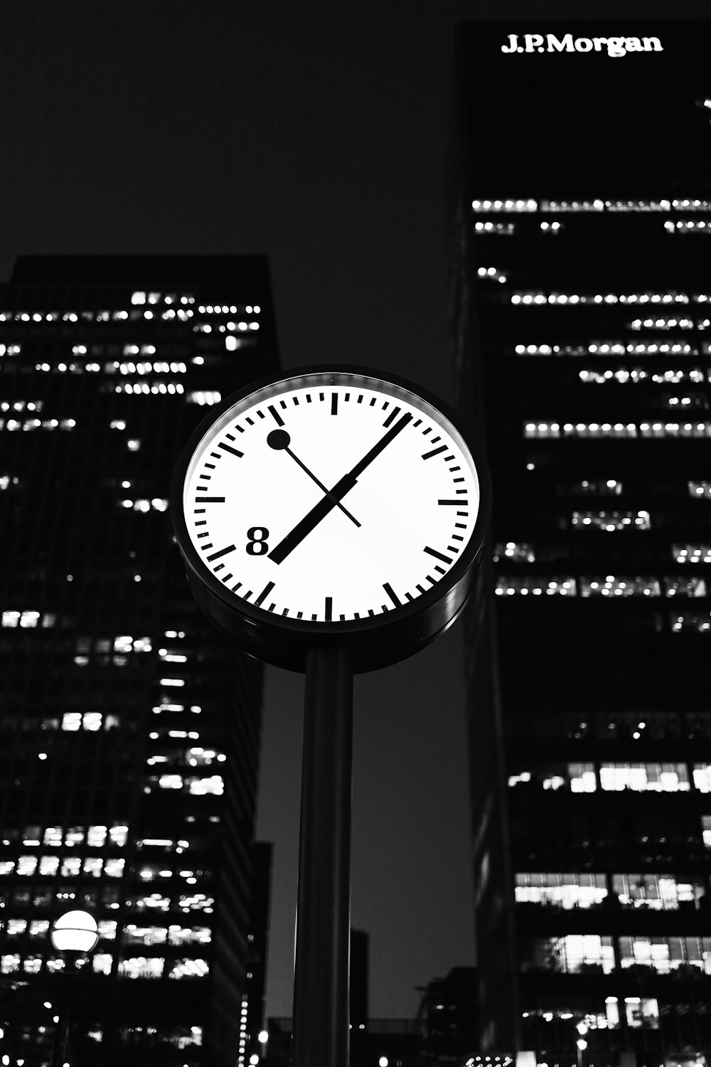 black and white analog wall clock at 10 00