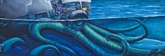 A mural featuring a large octopus underwater with its tentacles reaching up towards a spacecraft or satellite. The scene conveys a blend of science fiction and marine imagery, with vibrant blue and green colors dominating the composition.