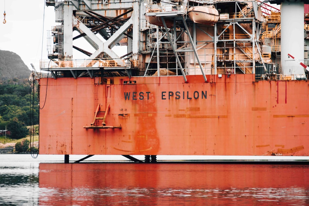 orange and white ship on water