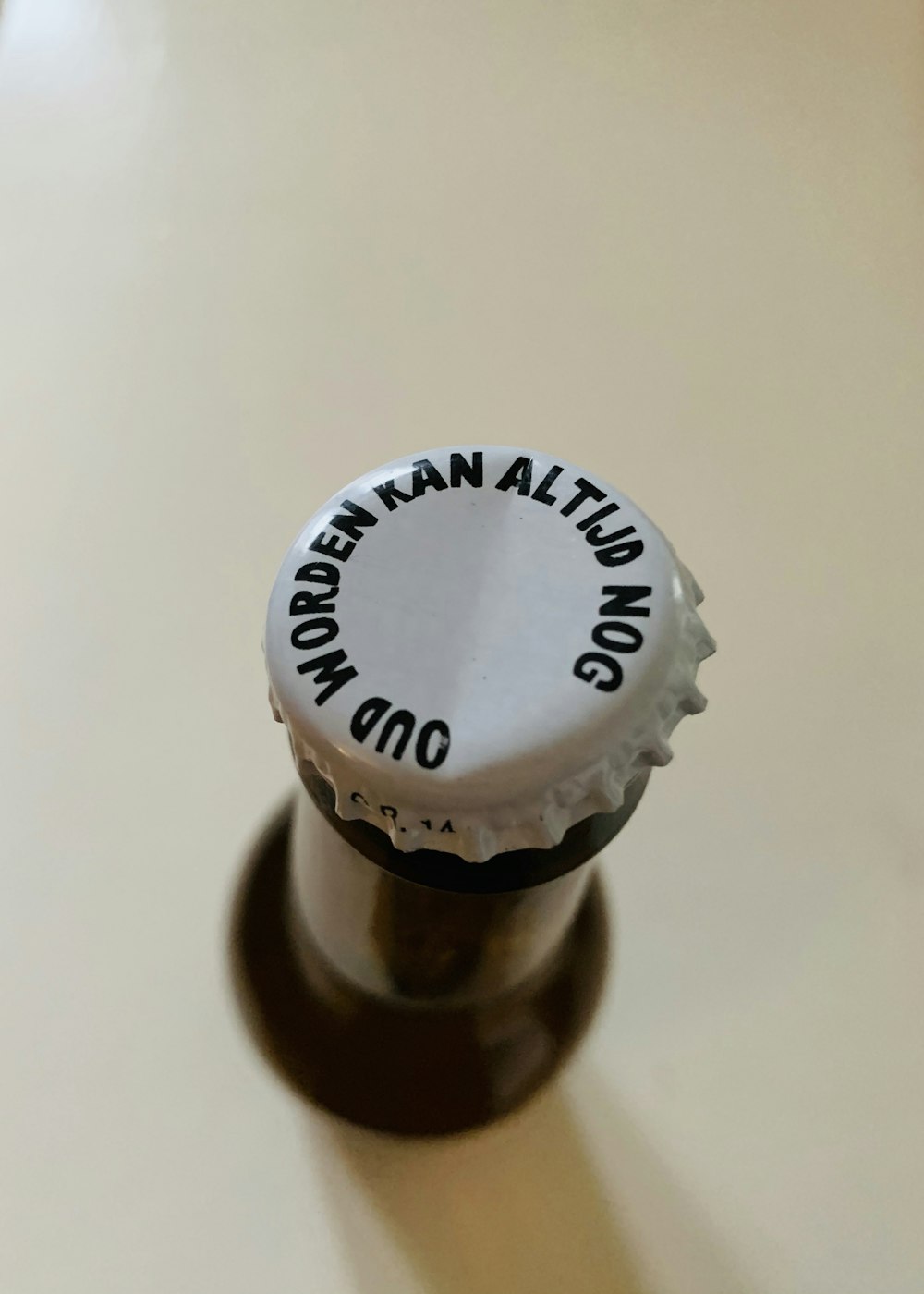 brown glass bottle on white table