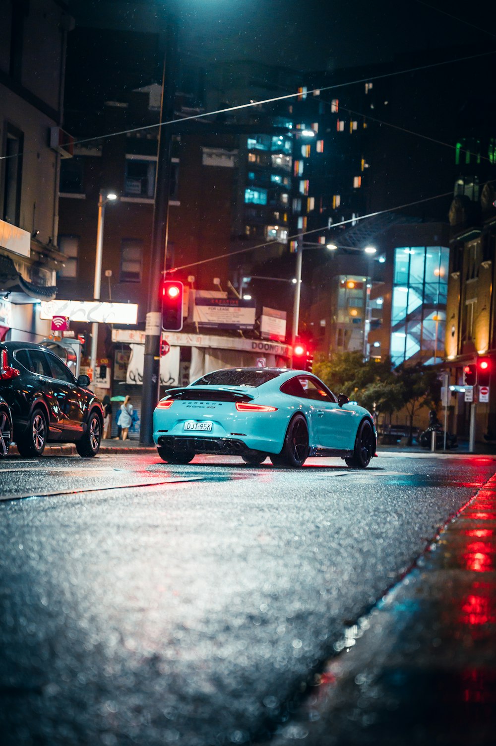 blue sedan on road during daytime