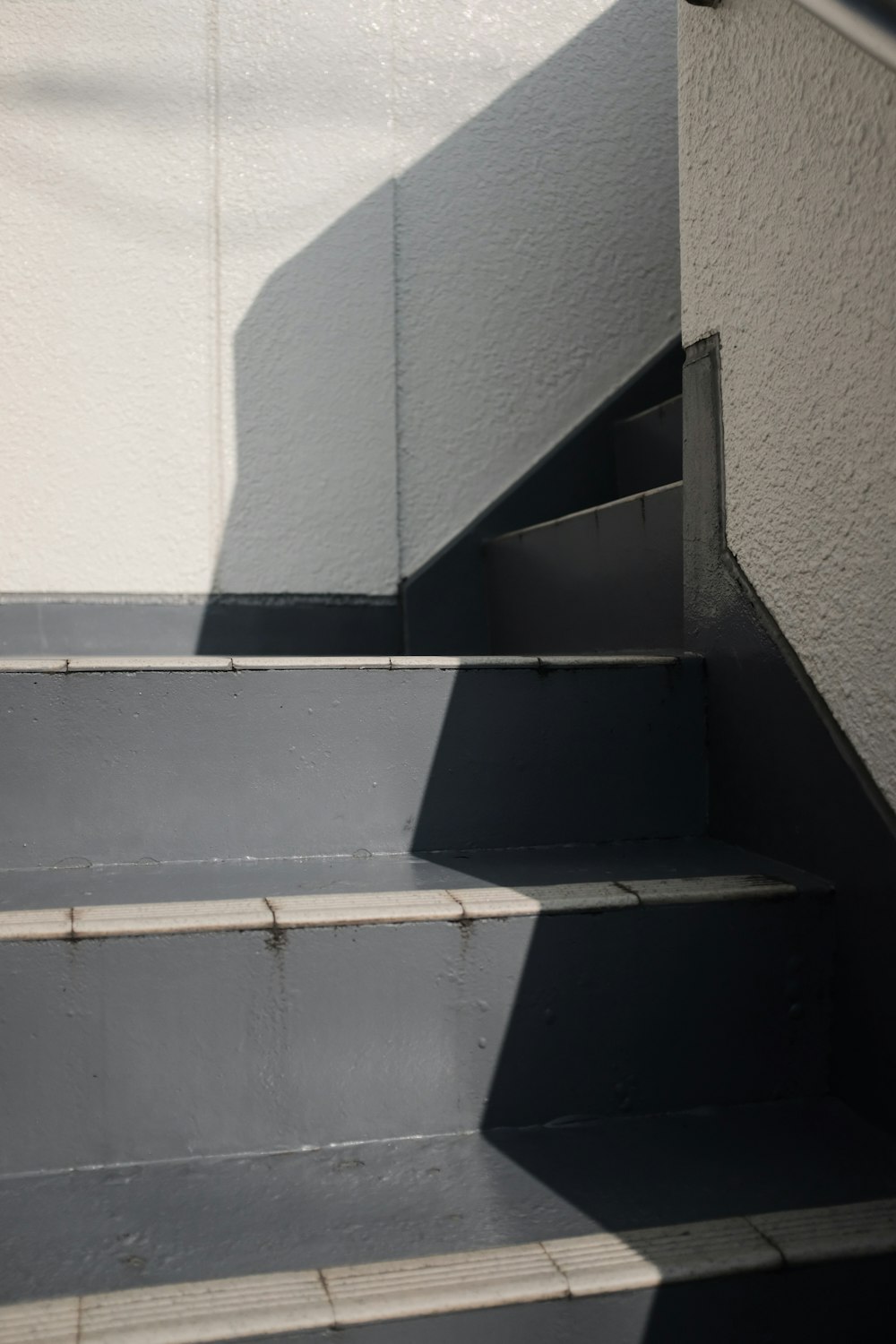 white concrete stairs with black metal railings