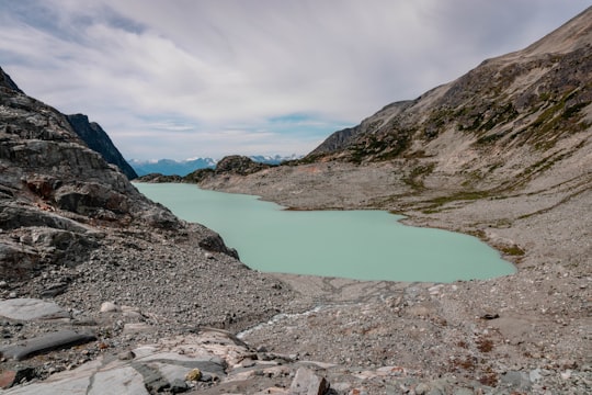 lake in the middle of mountains in Wedgemount Lake Canada