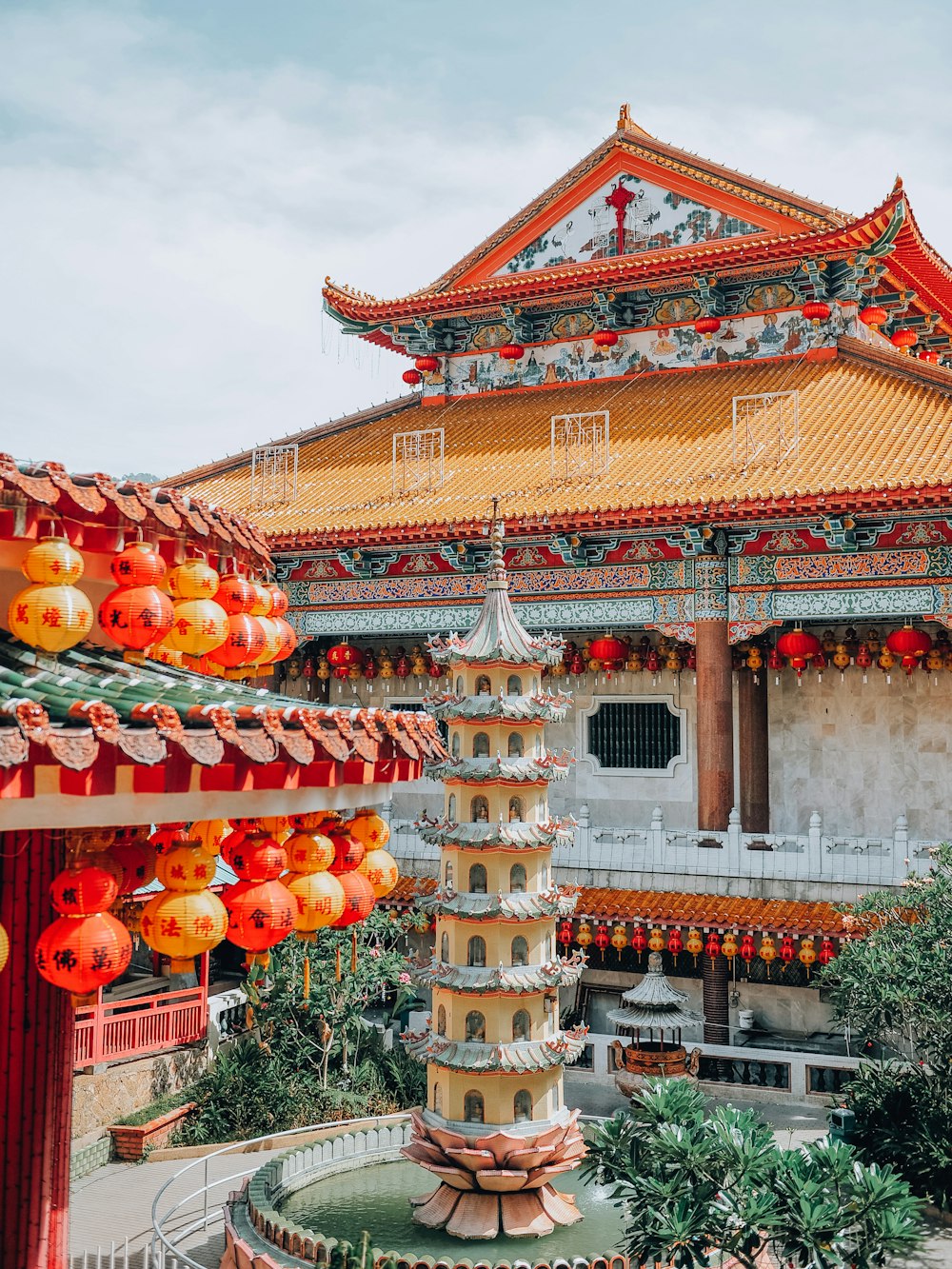 orange and yellow chinese lanterns on white concrete building during daytime