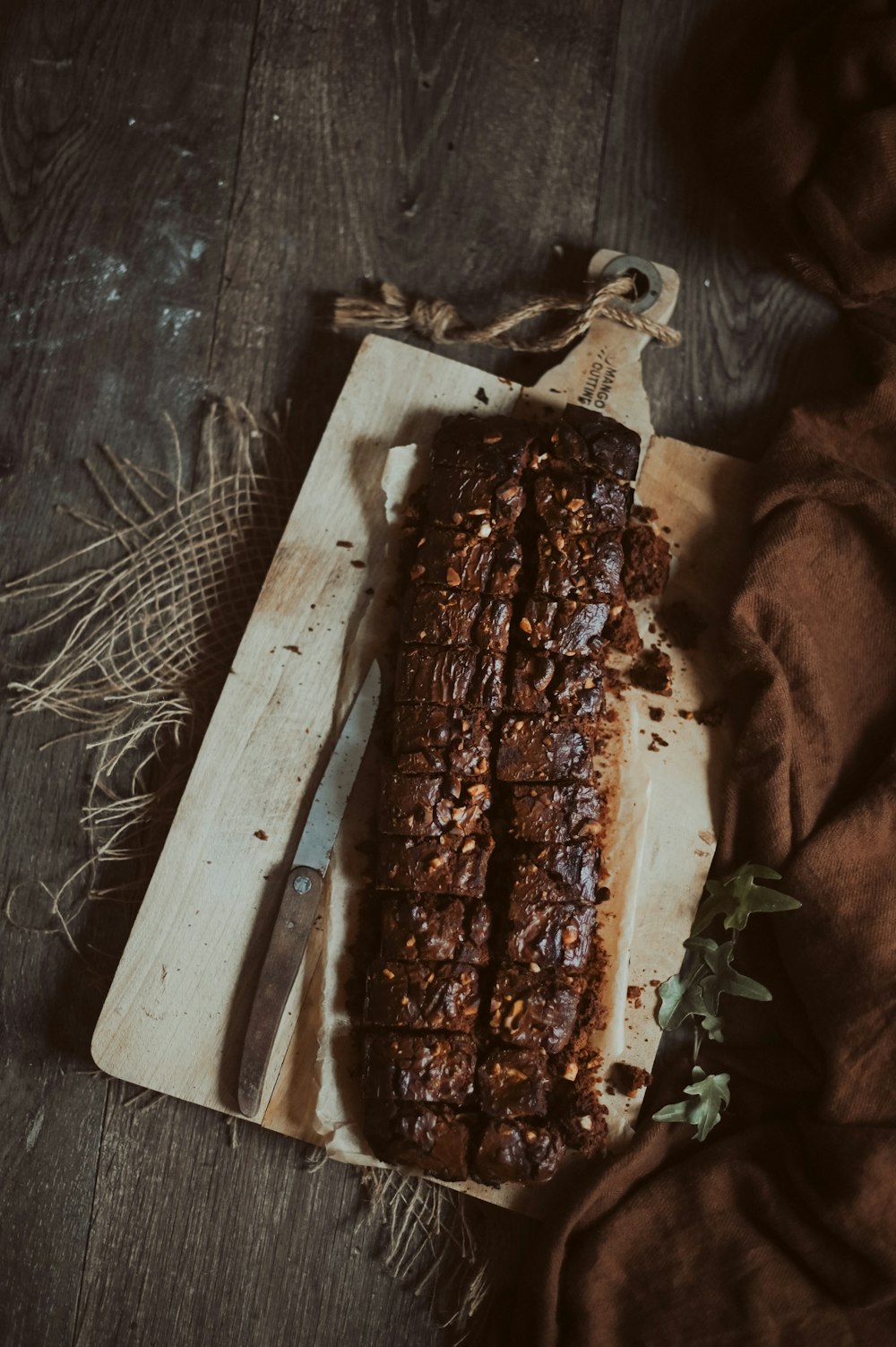 a loaf of bread on a cutting board with a knife