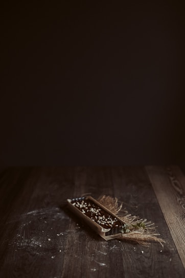 A rustic wooden table with a freshly baked tarte flambée steaming under soft natural light.