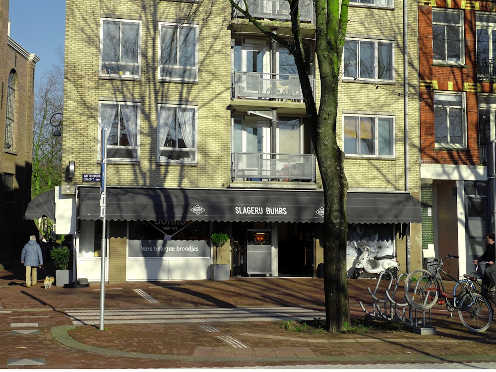 brown and white concrete building near green trees during daytime