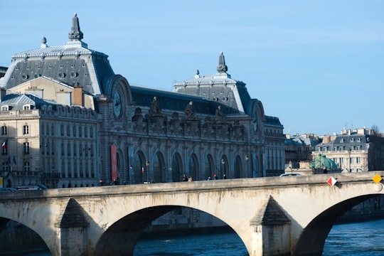 white and red concrete building near body of water during daytime in Tuileries Garden France