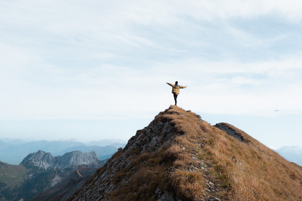 person standing on brown rock formation during daytime