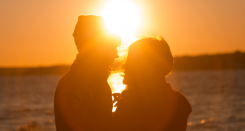 silhouette of man and woman during sunset