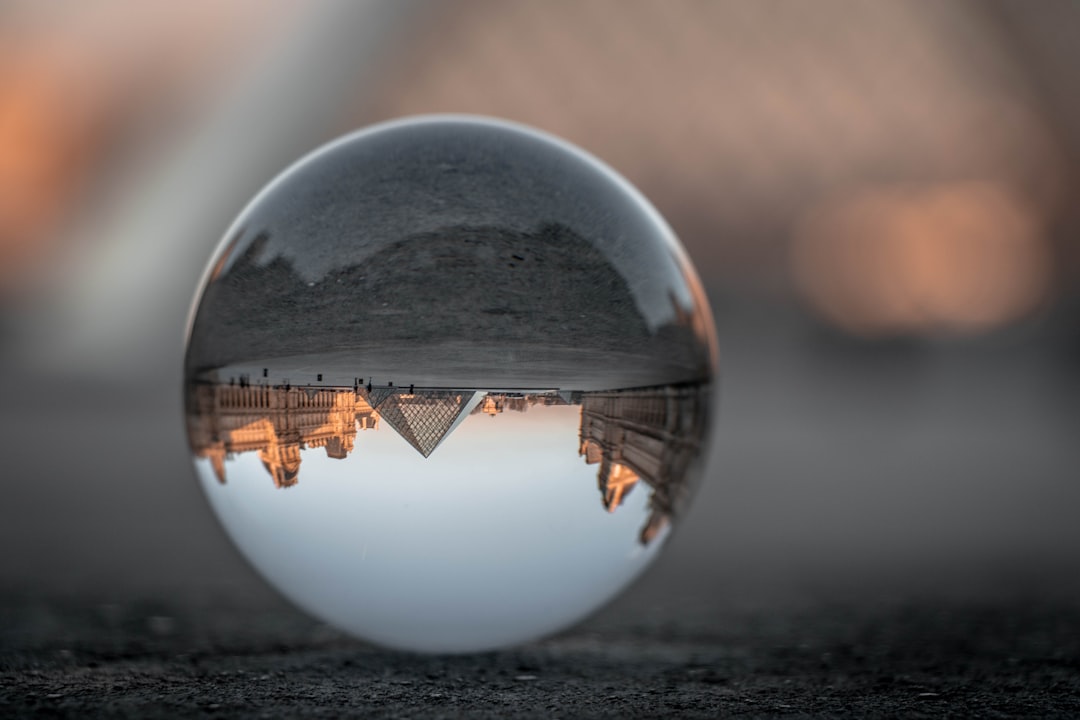 clear glass ball on gray concrete floor,