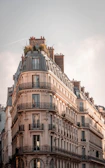 brown and white concrete building under white clouds during daytime