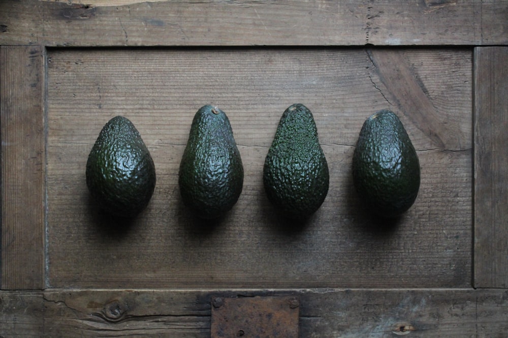 green oval fruits on brown wooden table