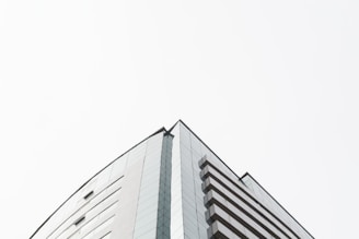 Sleek commercial complex with glass facade under clear sky.