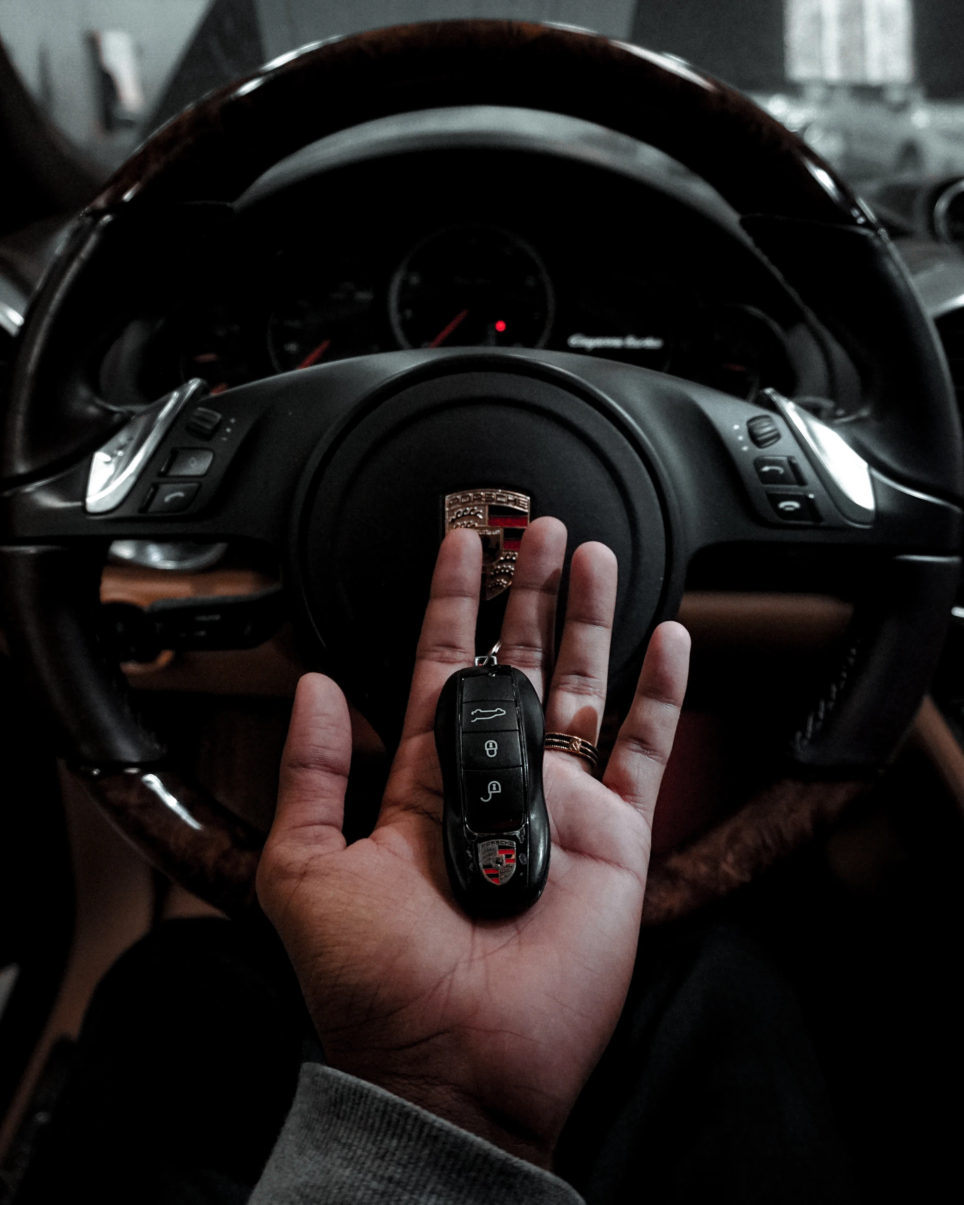 person holding black car fob