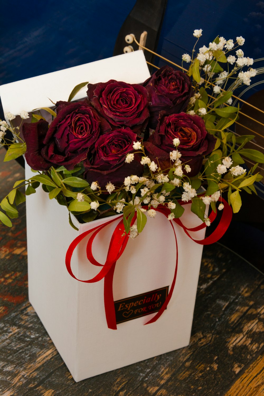 red roses in white ceramic vase