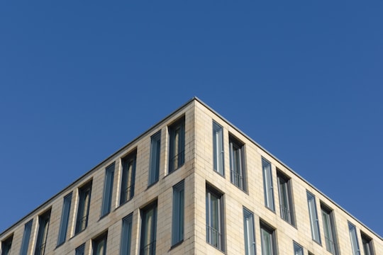 white concrete building under blue sky during daytime in Schwanthalerhöhe Germany