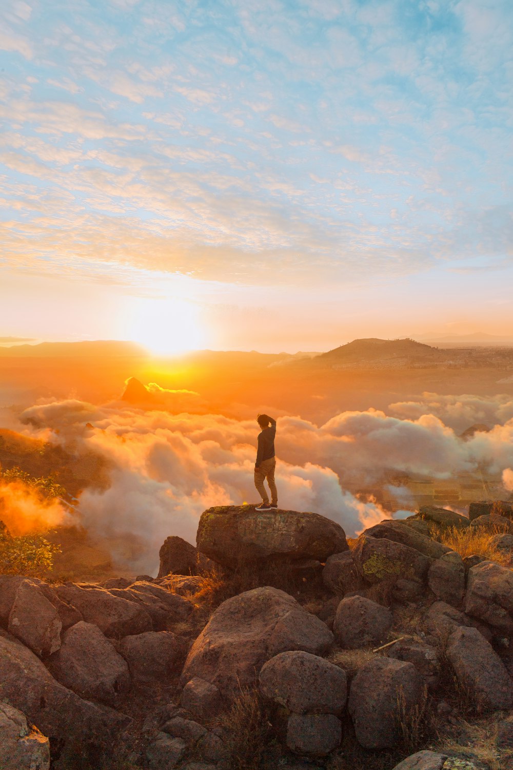 person standing on rock formation during daytime